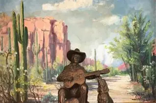 A statue of a man playing guitar and a dog.