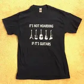 A black t-shirt with the words it's not hoarding if its guitars.