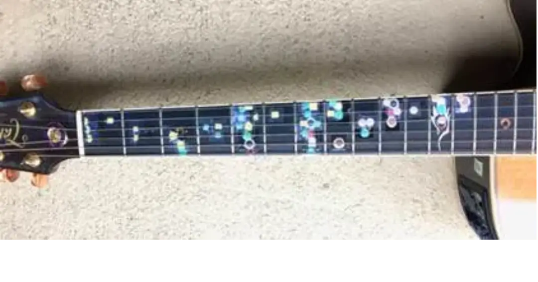 A guitar with some colorful dots on it